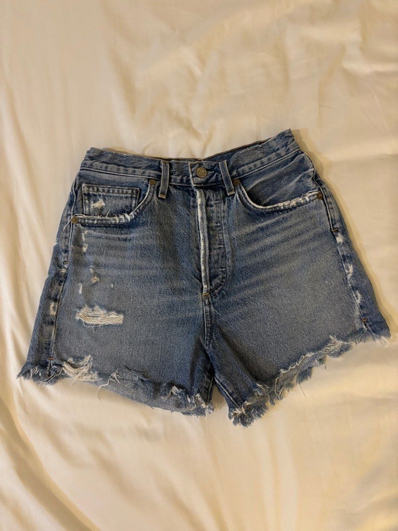 Agolde Dee High Rise Short in Riccochet (Category: Shorts) located in Taguig. Submitted by prelovedfits_ (Listing ID 1391195042, Image 2). Description: Style: Dee Colorway: Riccochet Size on tag: 26in Actual waistline (tape measure): 26in NO WHEN WORN - 100% cotton - Light fading and whiskering along front - Intentionally destroyed detail - Button fly - Front and back pockets - Side seam slits - Shorts measure approx 34 cm in length.