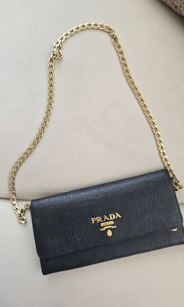Authentic Black prada wallet on chain (Category: Luxury Bags & Wallets) located in Paranaque City. Submitted by jsg23 (Listing ID 1391213160, Image 1). Description: with minor scuffings, chain is still gold. comes with card and dustbag.