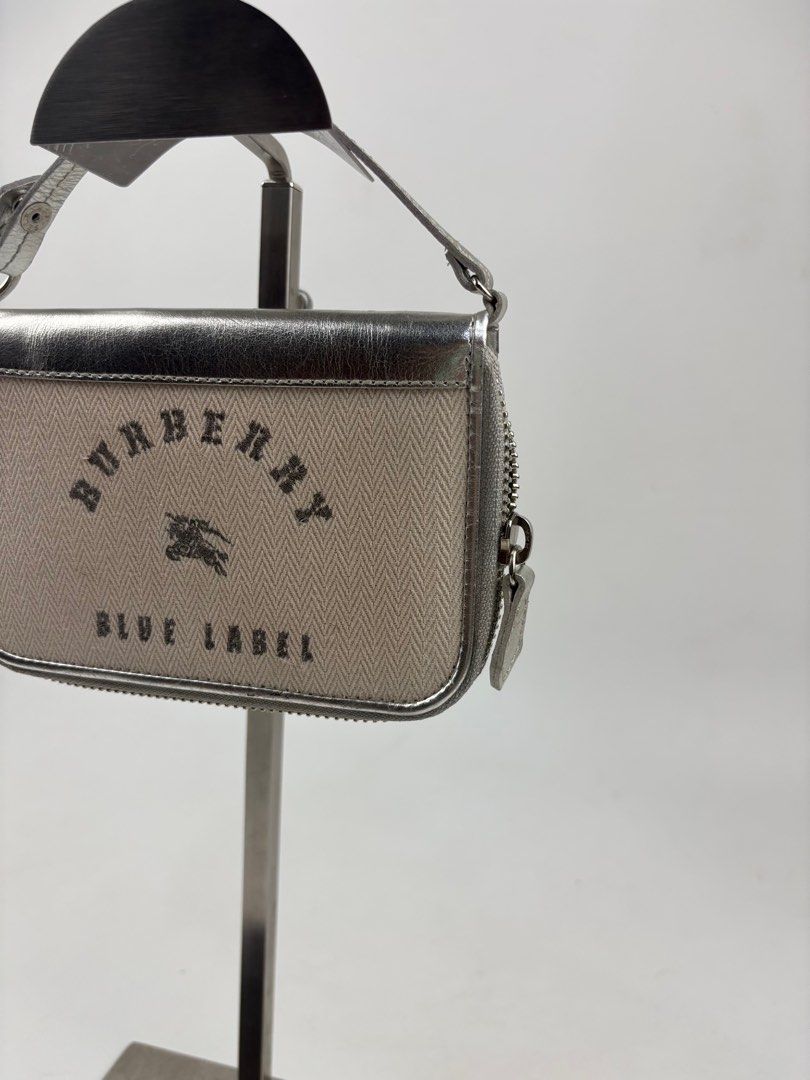 Burberry Blue Label Top Handle Wallet (Category: Luxury Bags & Wallets) located in Makati City. Submitted by ragrepository (Listing ID 1391318282, Image 3). Description: Burberry Blue Label Top Handle Wallet Height- 4” Width- 6” Depth- Strap drop- 2” Condition-9/10 Flaw- Minor signs of wear .