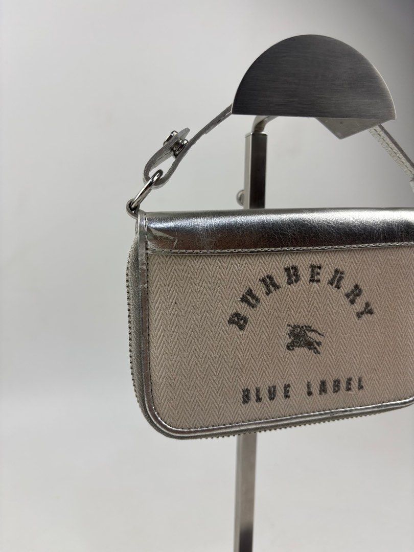 Burberry Blue Label Top Handle Wallet (Category: Luxury Bags & Wallets) located in Makati City. Submitted by ragrepository (Listing ID 1391318282, Image 2). Description: Burberry Blue Label Top Handle Wallet Height- 4” Width- 6” Depth- Strap drop- 2” Condition-9/10 Flaw- Minor signs of wear .