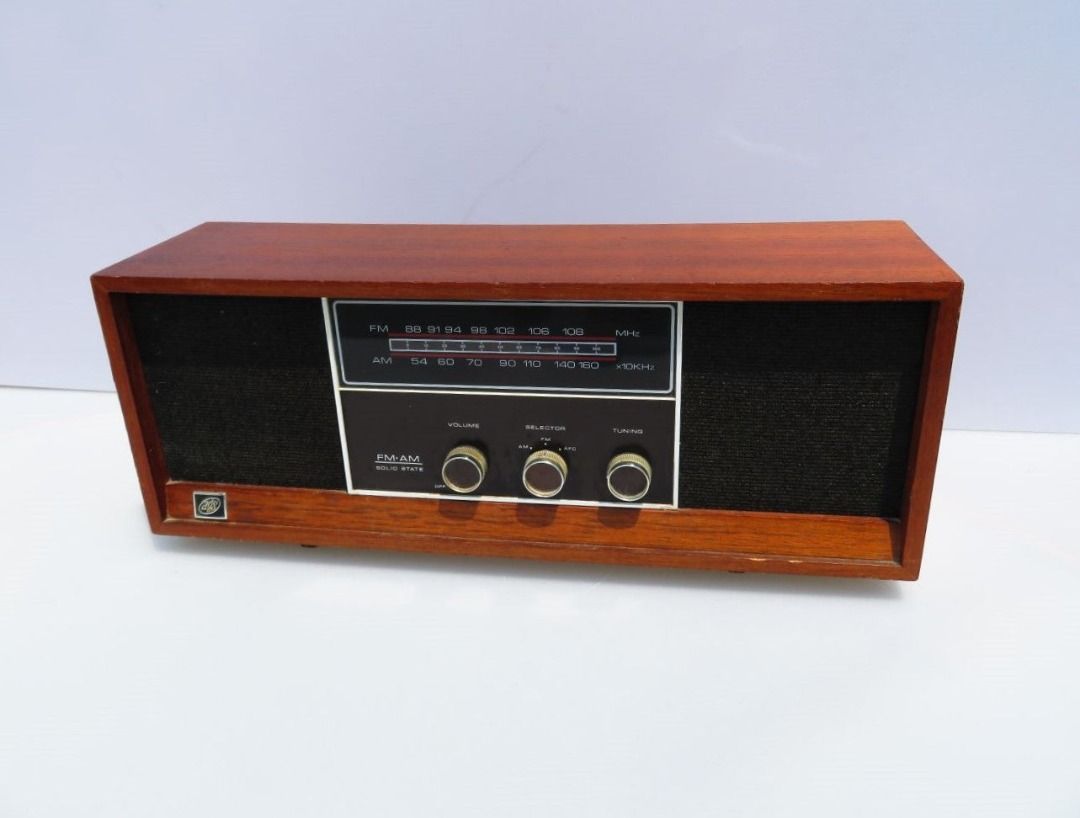 Mid Century Teak Radio (120v) (Category: Vintage Collectibles) located in Kuala Selangor. Submitted by my_ezupcycle (Listing ID 1391159183, Image 1). Description: Mid-century AM/FM radio, made in Japan, with a long, low cabinet in teak finish, black woven grilles, and knurled metal knobs. The look is pure late-60s/early-70s modern—clean lines, silver trim, and a horizontal dial that is truly 'period-correct'. It plays well (solid-state, AM/FM wit