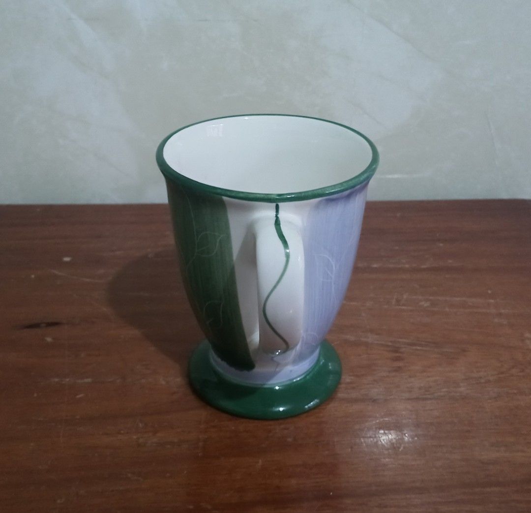 Vintage Style Footed Coffee Mug (Category: Coffee & Tea Tableware) located in Bulacan. Submitted by honhonliz (Listing ID 1391197853, Image 3). Description: Brand new. Never been used, kept in stored cabinet. Original box damaged, cn't be included. Last photo, for vintage proof of this mug only 😊 Material: It appears to be made of ceramic or porcelain, common materials for coffee mugs. Design: The mug features a footed base and a decorative patt