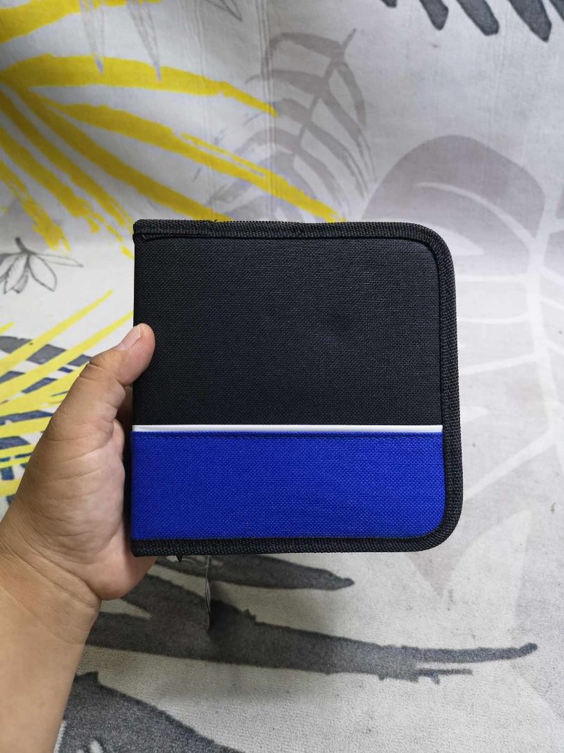 Blue black CD Storage (Category: Portable Audio Accessories) located in Santa Cruz. Submitted by jmy_surplus.2 (Listing ID 1391427642, Image 2). Description: Size ; L - 6 W - 6.2 Color ; Blue Black Type ; CD Storage Brand ; No brand Material ; Nylon Style ; Blue Black CD Storage LG 119 JMY 5 Batch #147.