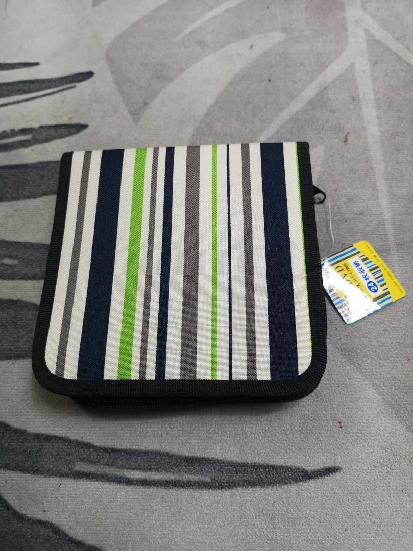 Green Black Zip Around Stripe CD Storage (Category: Portable Audio Accessories) located in Santa Cruz. Submitted by jmy_surplus.2 (Listing ID 1391425284, Image 1). Description: Size ; L - 6 W - 6.2 Color ; Black , green Type ; Cd Storage Brand ; No brand Material ; Nylon Style ; Stripe CD Storage LG 119 JMY 5 Batch #147.