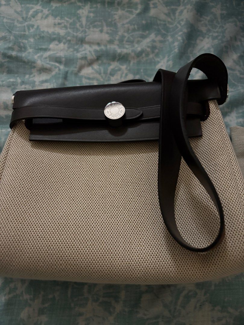 Hermes Mini Her Bag Leather Canvas Palladium Hardware (Category: Luxury Bags & Wallets) located in Taguig. Submitted by gigie24 (Listing ID 1391500119, Image 3). Description: Mini Herbag Leather Canvas Palladium Hardware - Pre love from Japan with Dust Bag only cannot guarantee authenticity Measurements: 8" width x 6.5" height x 2.5" depth; 18" shoulder strap drop Hermès Herbag Zip 20 Mini Ecru and Beige Toile H canvas and Ebene Vache Hunter with