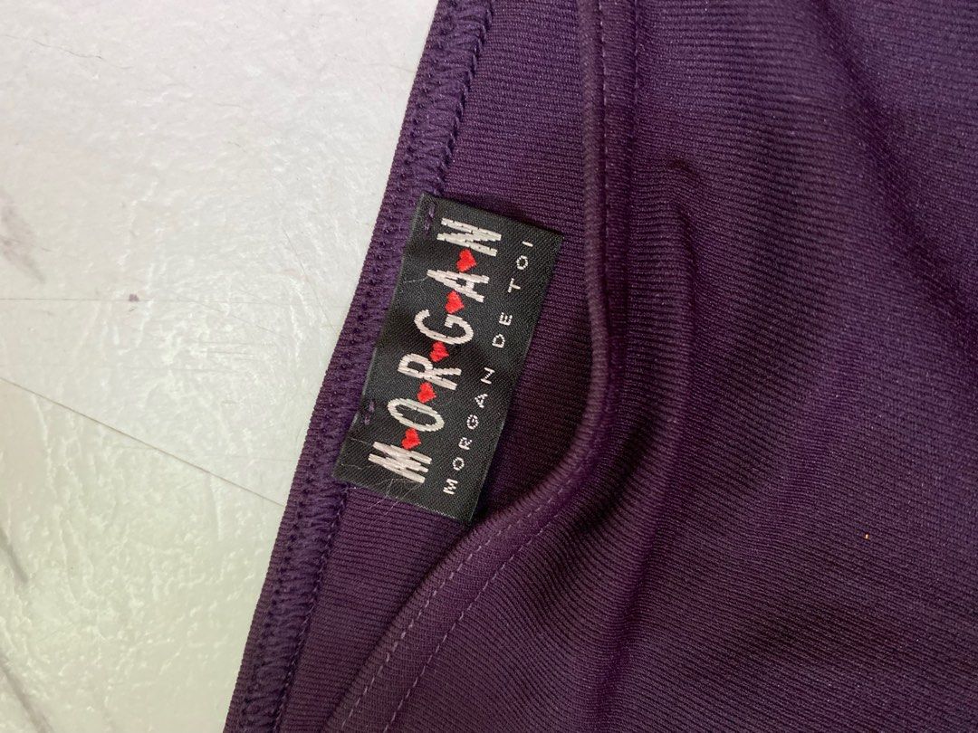 Morgan De Toi (Category: Skirts) located in Mangaldan. Submitted by avaph (Listing ID 1391359895, Image 2). Description: Morgan de Toi Purple Mini Skirt – Size 27-28 S/M, Geometric Logo Trim Price: ₱700 Description: Add a chic twist to your wardrobe with this Morgan de Toi bodycon mini skirt in a rich purple hue. The piece is made from a comfortable knit and features a unique turquoise and gold geometric print along the hem with repeated “MORGAN”