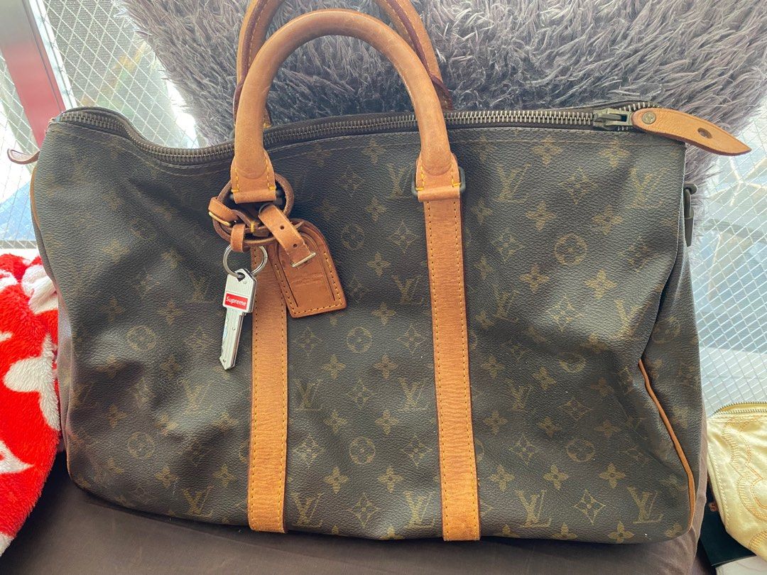 LOUIS VUITTON KEEPALL 45 with padlock/2keys- ANTIQUE (Category: Luxury Bags & Wallets) located in Makati City. Submitted by celebrityauctions (Listing ID 1391563792, Image 1). Description: “INCLUSIVE OF THE NEW KEY CHAIN”The image displays a vintage Louis Vuitton Keepall 45 bag. The Louis Vuitton Keepall 45 is a classic and popular travel bag known for its spacious interior and durable design. The “45” in its name refers to its length in centimet