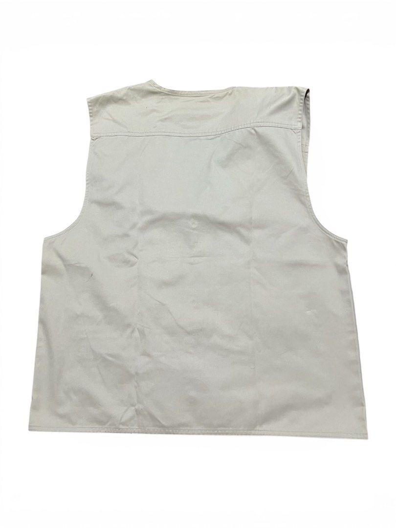 Beige Multi-Pocket Vest (Category: Vests) located in Caloocan City. Submitted by theaesthetics_ (Listing ID 1413026703, Image 2). Description: - Beige vest - Multiple pockets: 2 chest (button) - Button-down front - Small patch on right chest - Durable material (possibly cotton) - Classic, functional design Width - 21.5 Length - 25 One broken zipper.
