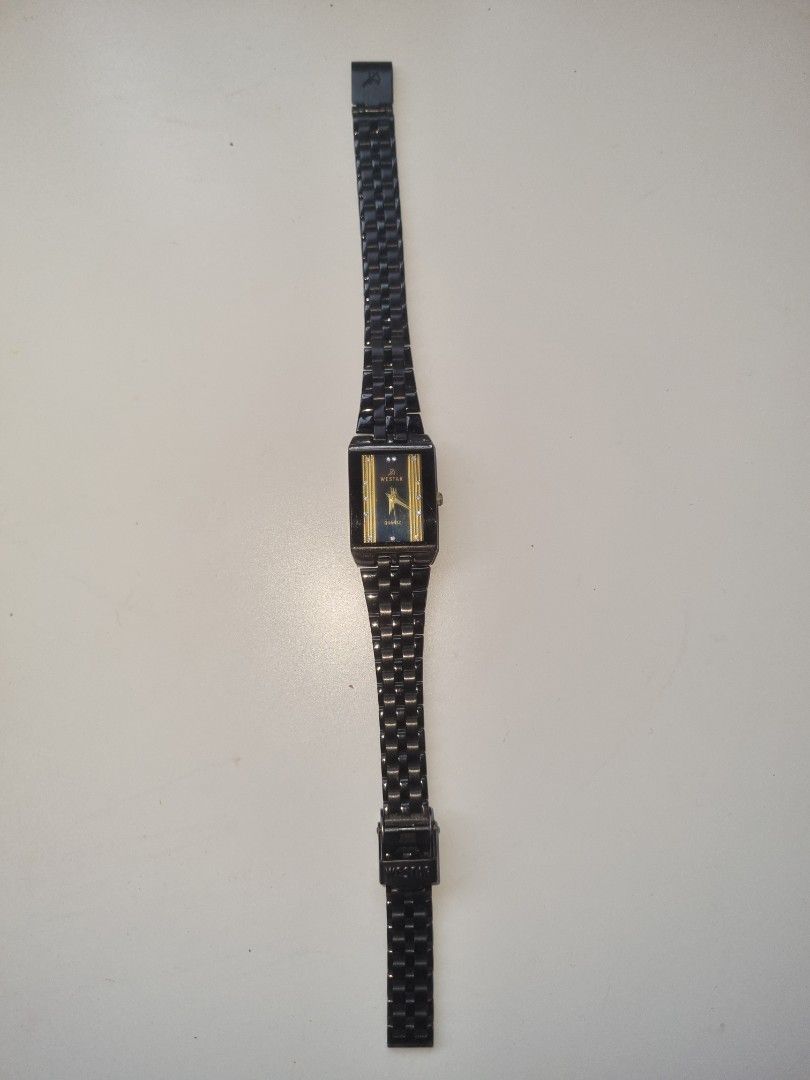 Black Rectangular Watch (Category: Women's Watches) located in Singapore. Submitted by livewind-416c5c (Listing ID 1412907219, Image 1). Description: - WORKING CONDITION - Stylish black rectangular watch - Features a black metal band - Gold-accented face - Vintage - Ideal for everyday wear or as a gift.