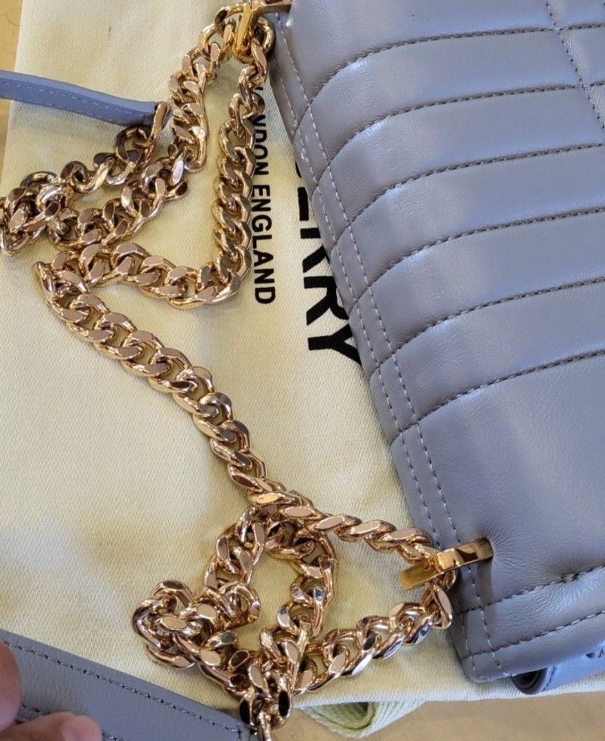 Burberry Lola Quilted Bag (Category: Luxury Bags & Wallets) located in Manila. Submitted by ddidl (Listing ID 1412978847, Image 2). Description: - NGA, Japan Sourced - Quilted design - Gold-tone chain strap - Flap closure with TB logo - Interior lined - "Made in Italy" label - Includes dust bag - Color: Light blue/grey location: Manila or Pasay. can do lalamove or grab MOP: BDO and Gcash only.