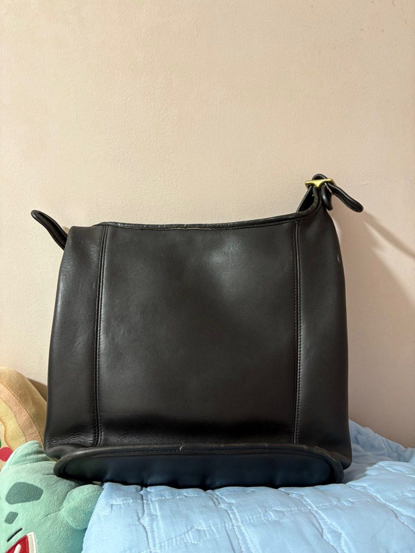 Coach Vintage Classic Duffle Sac Shoulder Bag (Category: Luxury Bags & Wallets) located in Pasig City. Submitted by cheesebiscuit (Listing ID 1412872113, Image 2). Description: Selling this classic Coach shoulder bag in as-is condition. - Black leather - Spacious interior with zippered closure - Exterior pocket - Includes Coach leather tag - Adjustable strap - Brass hardware - Lined interior - Timeless and versatile RFS: not used anymore, found i