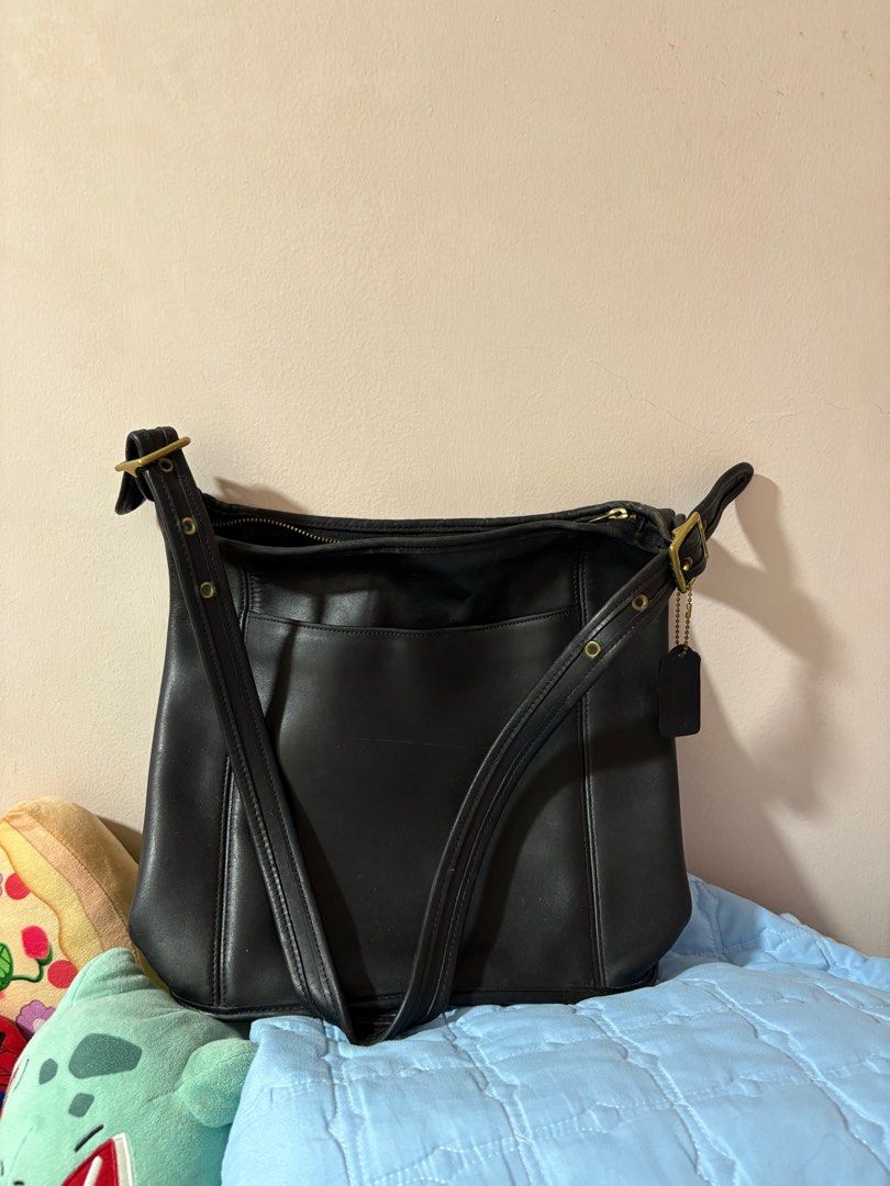 Coach Vintage Classic Duffle Sac Shoulder Bag (Category: Luxury Bags & Wallets) located in Pasig City. Submitted by cheesebiscuit (Listing ID 1412872113, Image 1). Description: Selling this classic Coach shoulder bag in as-is condition. - Black leather - Spacious interior with zippered closure - Exterior pocket - Includes Coach leather tag - Adjustable strap - Brass hardware - Lined interior - Timeless and versatile RFS: not used anymore, found i