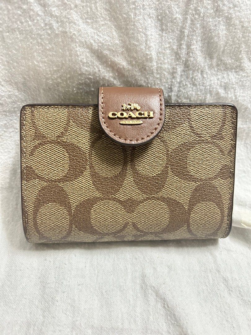 Coach Signature Medium Corner Zip Wallet (Category: Luxury Bags & Wallets) located in Pasig City. Submitted by sapphire09_monkey (Listing ID 1412965186, Image 2). Description: - Authentic Coach wallet - Signature print design - Snap closure - Multiple card slots - Zippered coin compartment - Brown leather interior and exterior - Coach logo - Comes with original tags Issue: no box.