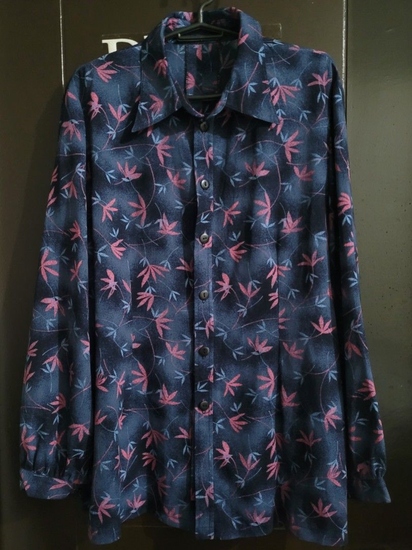 Floral Print Long Sleeve Shirt (Category: Blouses) located in Paranaque City. Submitted by mariam3842 (Listing ID 1413029326, Image 3). Description: - Dark blue long-sleeved shirt. - Features a floral pattern (pink and light blue). - Classic collar and button-down closure. - Can fit M-L sizes. - Buttoned cuffs. - Lightweight fabric. - Perfect for hot and warmer weather. "Note: The first photo is an AI-generated model for fit and styling reference