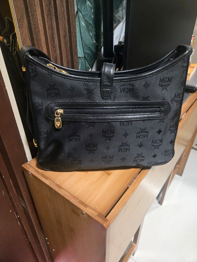 MCM Black Shoulder Bag Adjustable (Category: Luxury Bags & Wallets) located in Mandaluyong City. Submitted by personallpreloved (Listing ID 1412893182, Image 2). Description: - Authentic MCM shoulder bag - Black with gold-tone hardware - Includes top handle and shoulder strap - Secure zip closure - Signature MCM logo design - travel bag - Durable fabric/canvas construction with leather trim a little fading on metal detail length 30cm, height 20cm