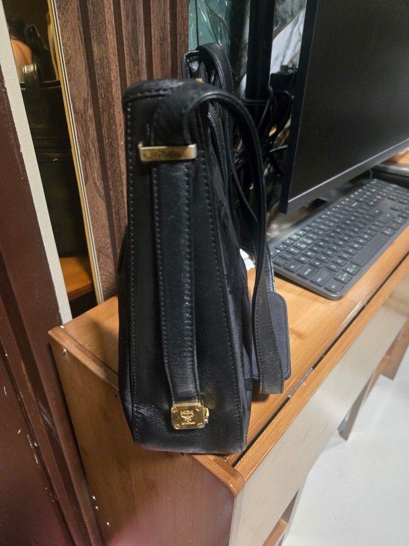 MCM Black Shoulder Bag Adjustable (Category: Luxury Bags & Wallets) located in Mandaluyong City. Submitted by personallpreloved (Listing ID 1412893182, Image 3). Description: - Authentic MCM shoulder bag - Black with gold-tone hardware - Includes top handle and shoulder strap - Secure zip closure - Signature MCM logo design - travel bag - Durable fabric/canvas construction with leather trim a little fading on metal detail length 30cm, height 20cm