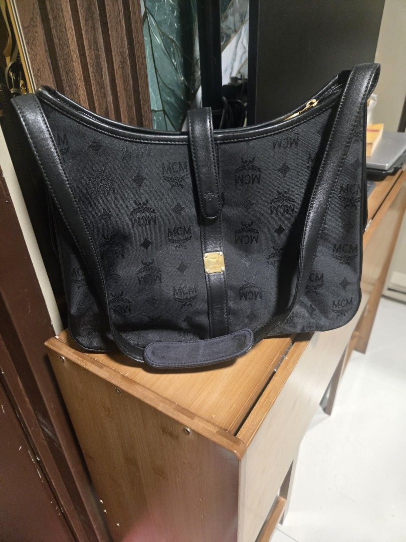 MCM Black Shoulder Bag Adjustable (Category: Luxury Bags & Wallets) located in Mandaluyong City. Submitted by personallpreloved (Listing ID 1412893182, Image 1). Description: - Authentic MCM shoulder bag - Black with gold-tone hardware - Includes top handle and shoulder strap - Secure zip closure - Signature MCM logo design - travel bag - Durable fabric/canvas construction with leather trim a little fading on metal detail length 30cm, height 20cm