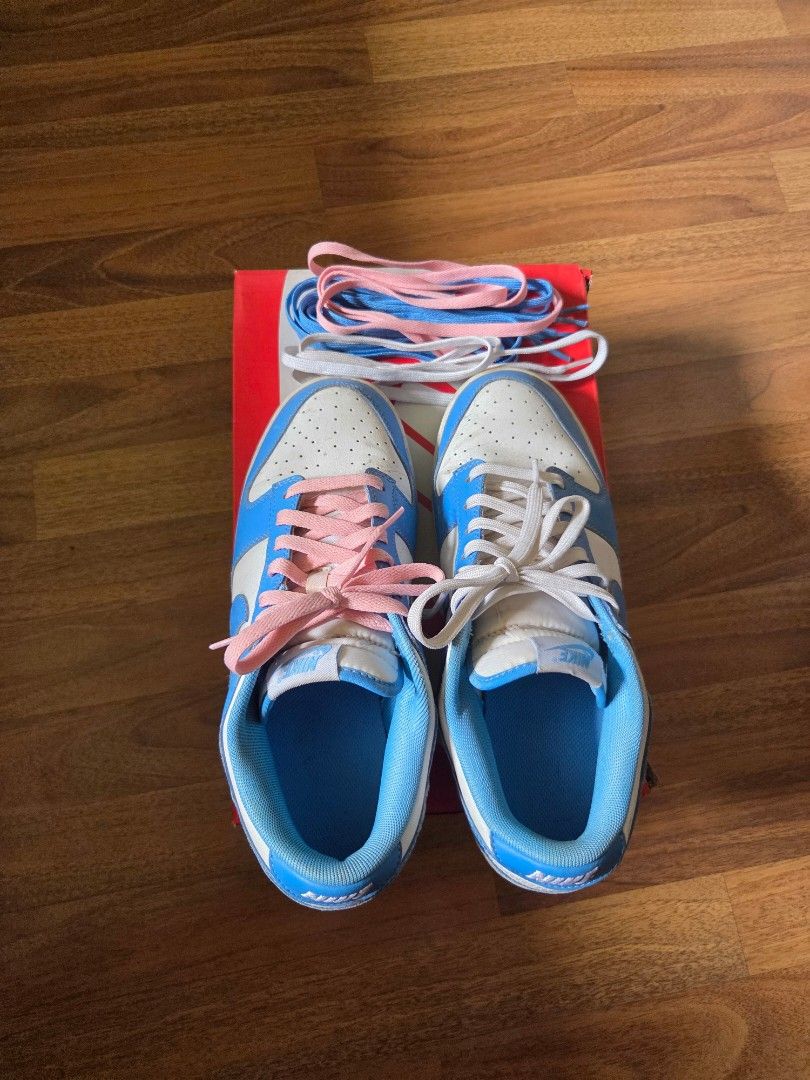 Nike Dunk Low UNC Light Blue (Category: Sneakers) located in Marikina City. Submitted by jerencinas (Listing ID 1412876898, Image 1). Description: Nike Dunk UNC Lows Well-used, comes with extra pink and white laces bought separately. (Original blue laces included) No original box (box used in pics is for a different shoe) .