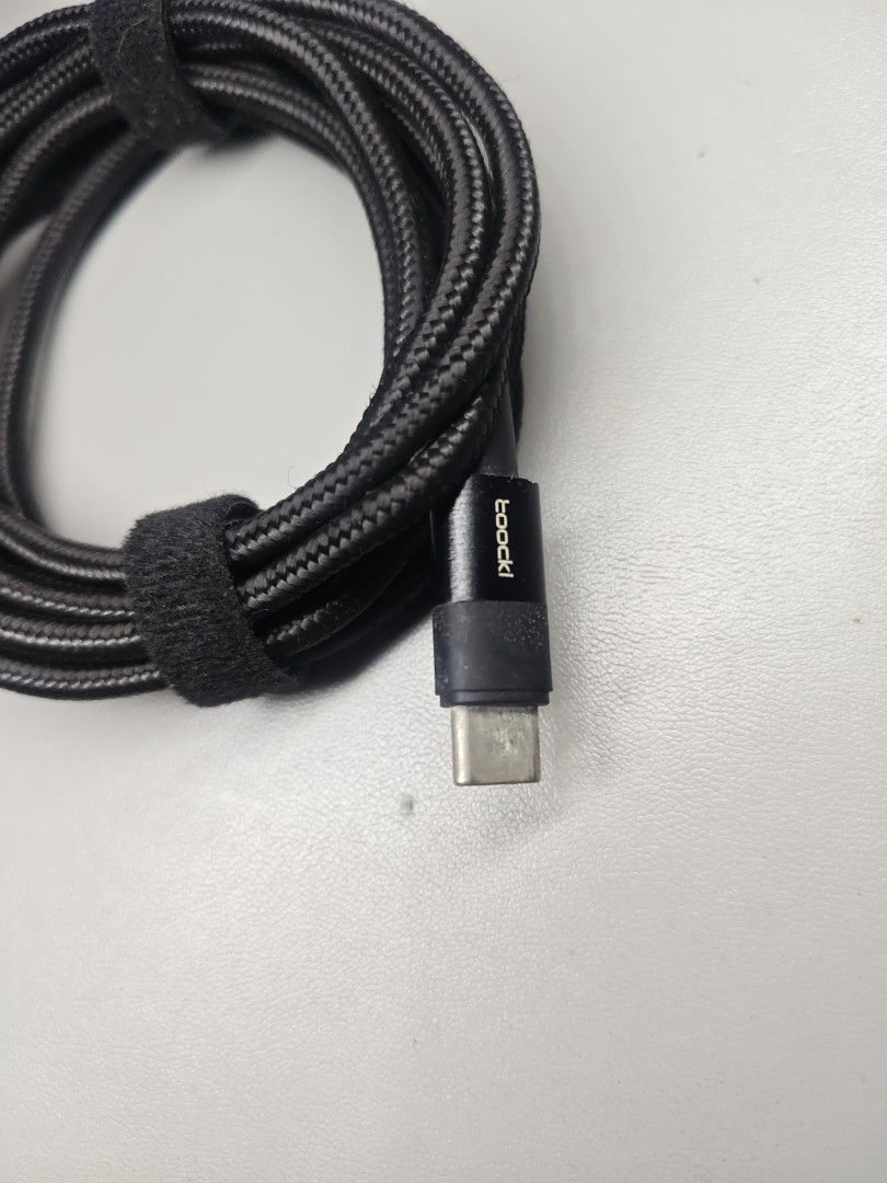 Toocki 100W 2 meters USB Type C to USB Type C Cable (Category: Chargers & Cables) located in Makati City. Submitted by tekhowz (Listing ID 1412938884, Image 2). Description: Toocki USB-C cable. It has a black braided design. The cable is neatly coiled and secured with a velcro strap. 100 Watts. Length 2 meters.