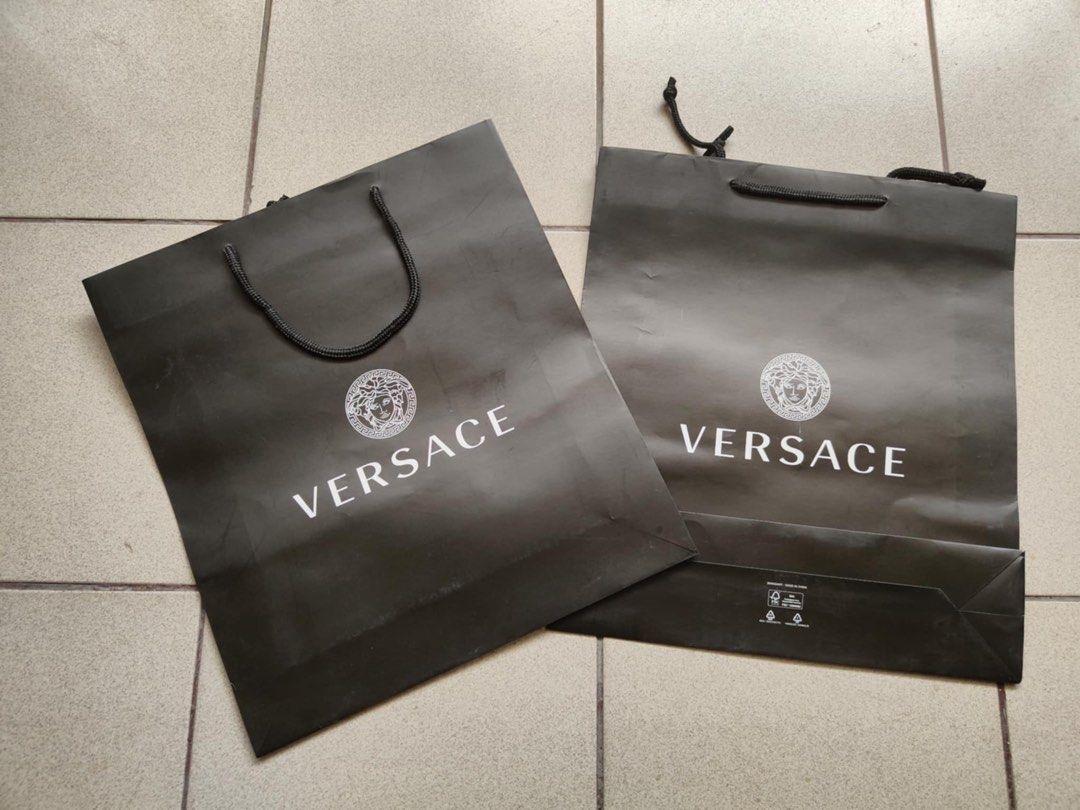 Versace Paper Bag (Category: Luxury Bags & Wallets) located in Manila. Submitted by beatthetrend (Listing ID 1412922699, Image 1). Description: - Authentic Versace paper bag - Features the iconic Versace logo - Includes a black handle - Perfect for gifting or collecting - Color: Black - size: 36x40cm - ₱400.00 each.