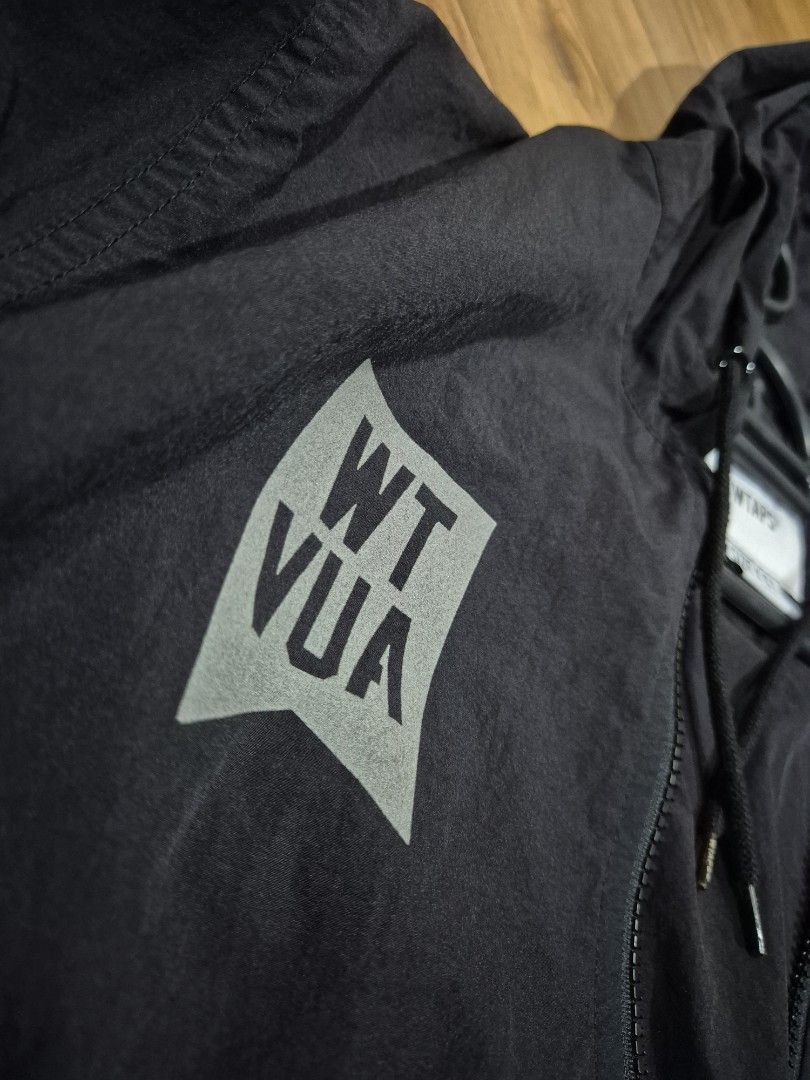 WTAPS (Category: Coats, Jackets and Outerwear) located in Kuala Lumpur. Submitted by satayhut (Listing ID 1412987641, Image 3). Description: - WTAPS black hooded jacket - Size: X 01 - Made in Japan - Full zip closure - WTAPS logo patch on chest and back - Drawstring hood - Lightweight material.