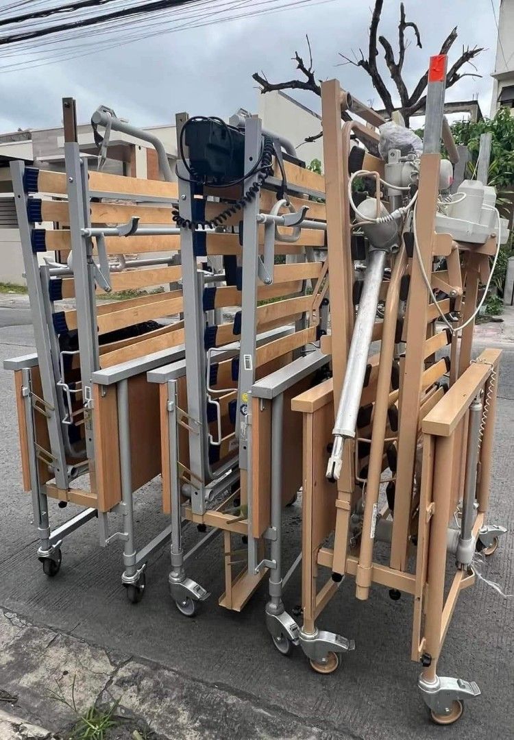 Adjustable Hospital Bed with Wheels (Category: Medical Supplies & Tools) located in Manila. Submitted by gracepangan_02 (Listing ID 1414688781, Image 2). Description: - Adjustable hospital bed - Wooden frame - Slatted base - Includes side table - Overhead support arm included - Features wheels for easy movement - Control panel for adjustments - Ideal for patient care and comfort.