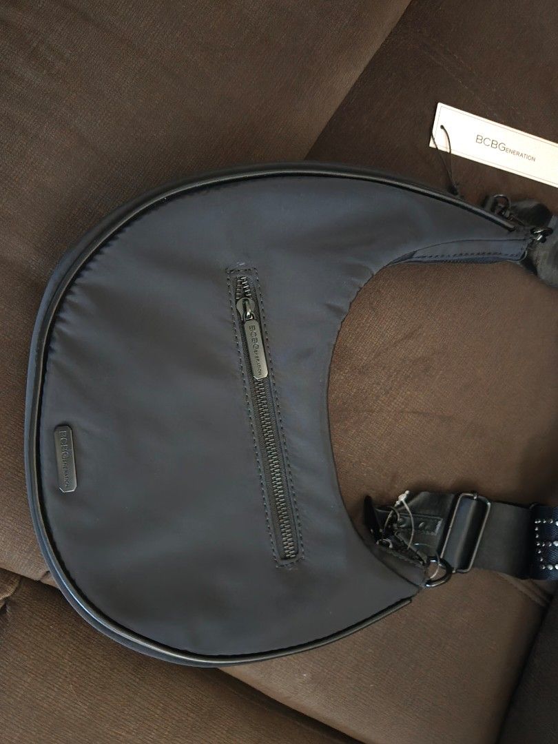 BcBG Bag Selling Low (lost strap) (Category: Luxury Bags & Wallets) located in Quezon City. Submitted by mgdeclutters (Listing ID 1414730875, Image 2). Description: - BCBG Generation handbag - Crescent shape - Black nylon exterior - Zippered closure - Includes brand tag selling low: lost bag strap.