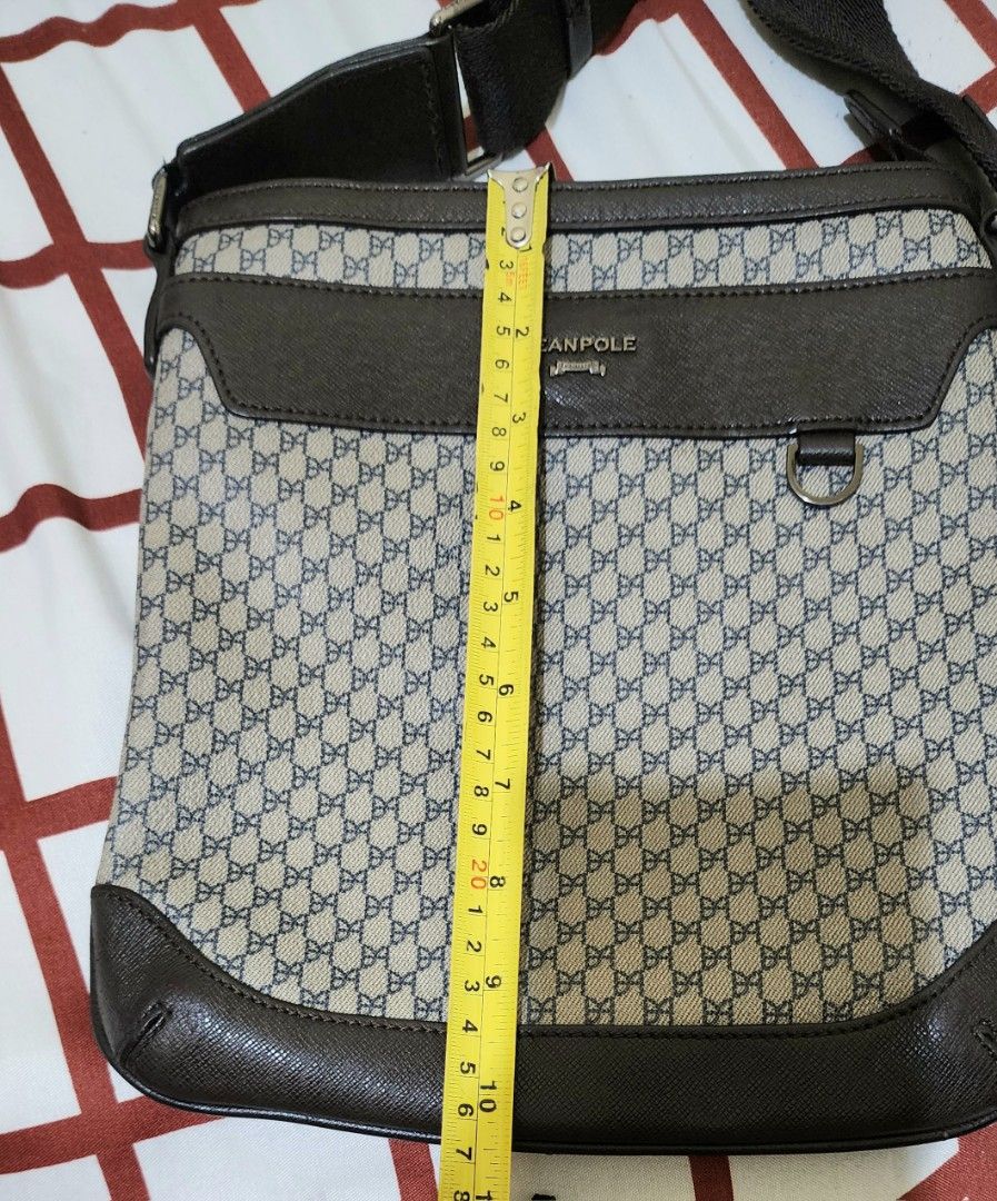 Beanpole Messenger Bag (Category: Luxury Bags & Wallets) located in Taguig. Submitted by mine2yours. (Listing ID 1414795196, Image 2). Description: - Stylish Beanpole messenger bag - Brown and beige patterned design - Brown leather trim - Adjustable shoulder strap - Zippered main compartment - Flap closure with metal ring - Interior zippered pocket - Perfect for everyday use.