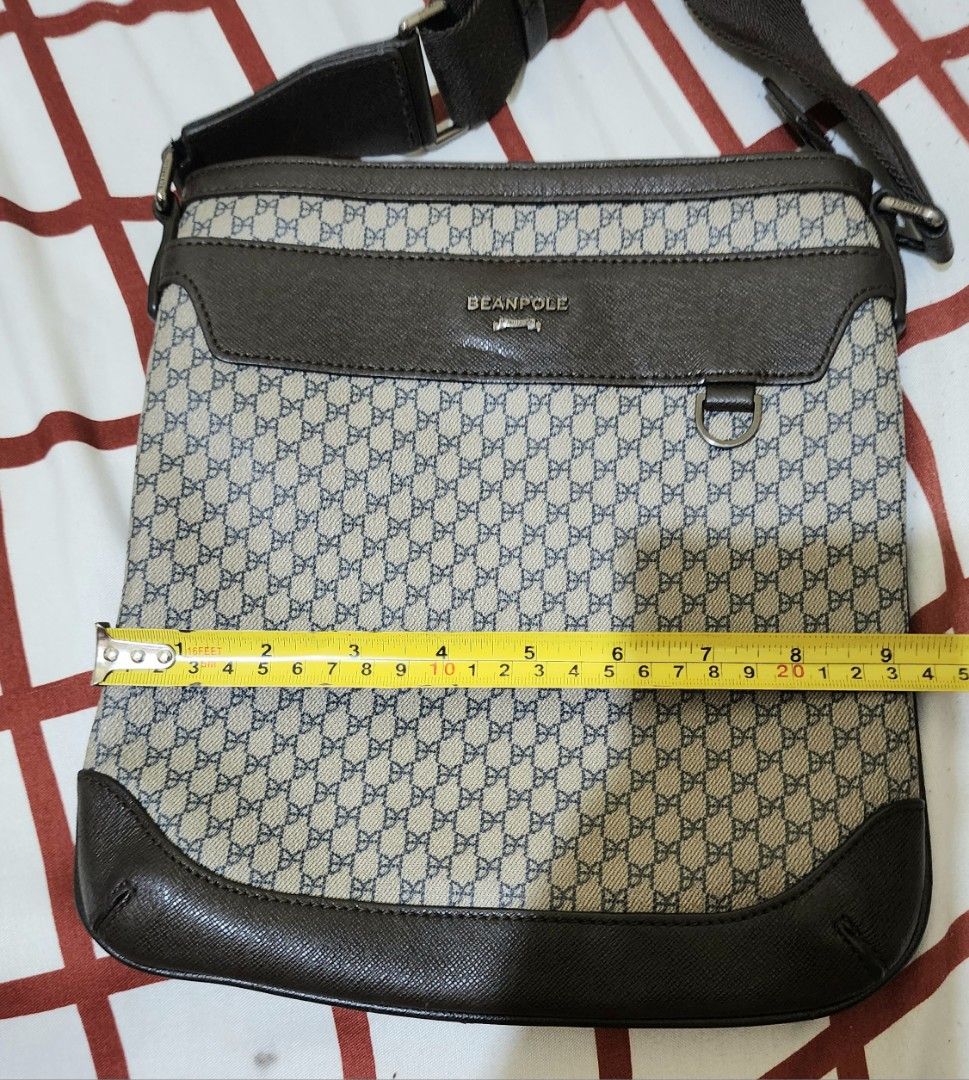 Beanpole Messenger Bag (Category: Luxury Bags & Wallets) located in Taguig. Submitted by mine2yours. (Listing ID 1414795196, Image 3). Description: - Stylish Beanpole messenger bag - Brown and beige patterned design - Brown leather trim - Adjustable shoulder strap - Zippered main compartment - Flap closure with metal ring - Interior zippered pocket - Perfect for everyday use.