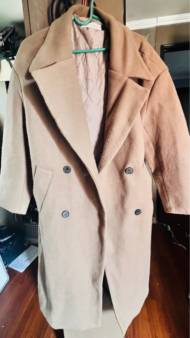 Beige Double-Breasted Coat (Category: Coats, Jackets and Outerwear) located in Caloocan City. Submitted by mayeth2813 (Listing ID 1414650219, Image 2). Description: - Beige double-breasted coat - Classic lapel collar - Soft, possibly wool-blend fabric - Long length (past knees) - Two front pockets - Quilted lining.