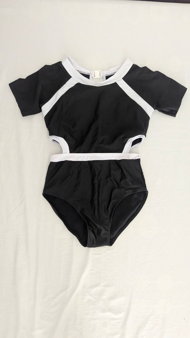 Black and White Cutout Swimsuit (Category: Bikinis & Swimsuits) located in Caloocan City. Submitted by dorbueittus (Listing ID 1414764045, Image 1). Description: - Stylish black swimsuit - White accents - Cutout design on sides - Short sleeves - High-waisted bottom - Keyhole back detail - Comfortable, stretchy material - Perfect for beach or pool.