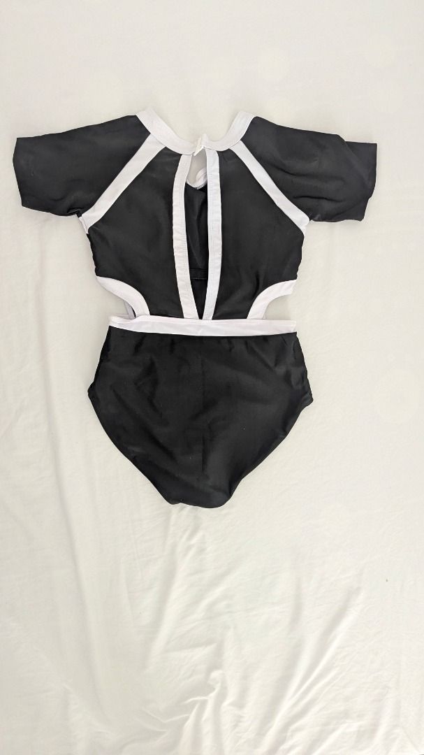 Black and White Cutout Swimsuit (Category: Bikinis & Swimsuits) located in Caloocan City. Submitted by dorbueittus (Listing ID 1414764045, Image 2). Description: - Stylish black swimsuit - White accents - Cutout design on sides - Short sleeves - High-waisted bottom - Keyhole back detail - Comfortable, stretchy material - Perfect for beach or pool.