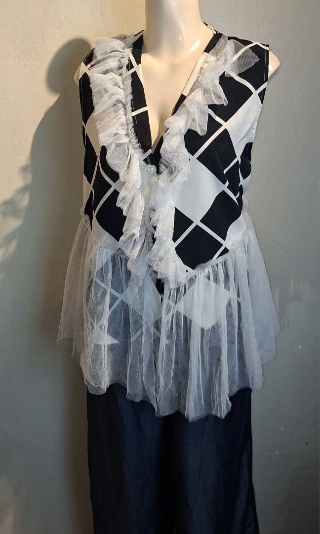 Black and White Ruffled Peplum Top (Category: Sleeveless) located in Cavite. Submitted by lovedbymjca (Listing ID 1414794047, Image 1). Description: Color: Black & White Design: Geometric print Neckline: V-neck with ruffle accents Hem: Sheer mesh peplum Style: Elegant, classy, and trendy Best paired with: Pants, skirts, or jeans.