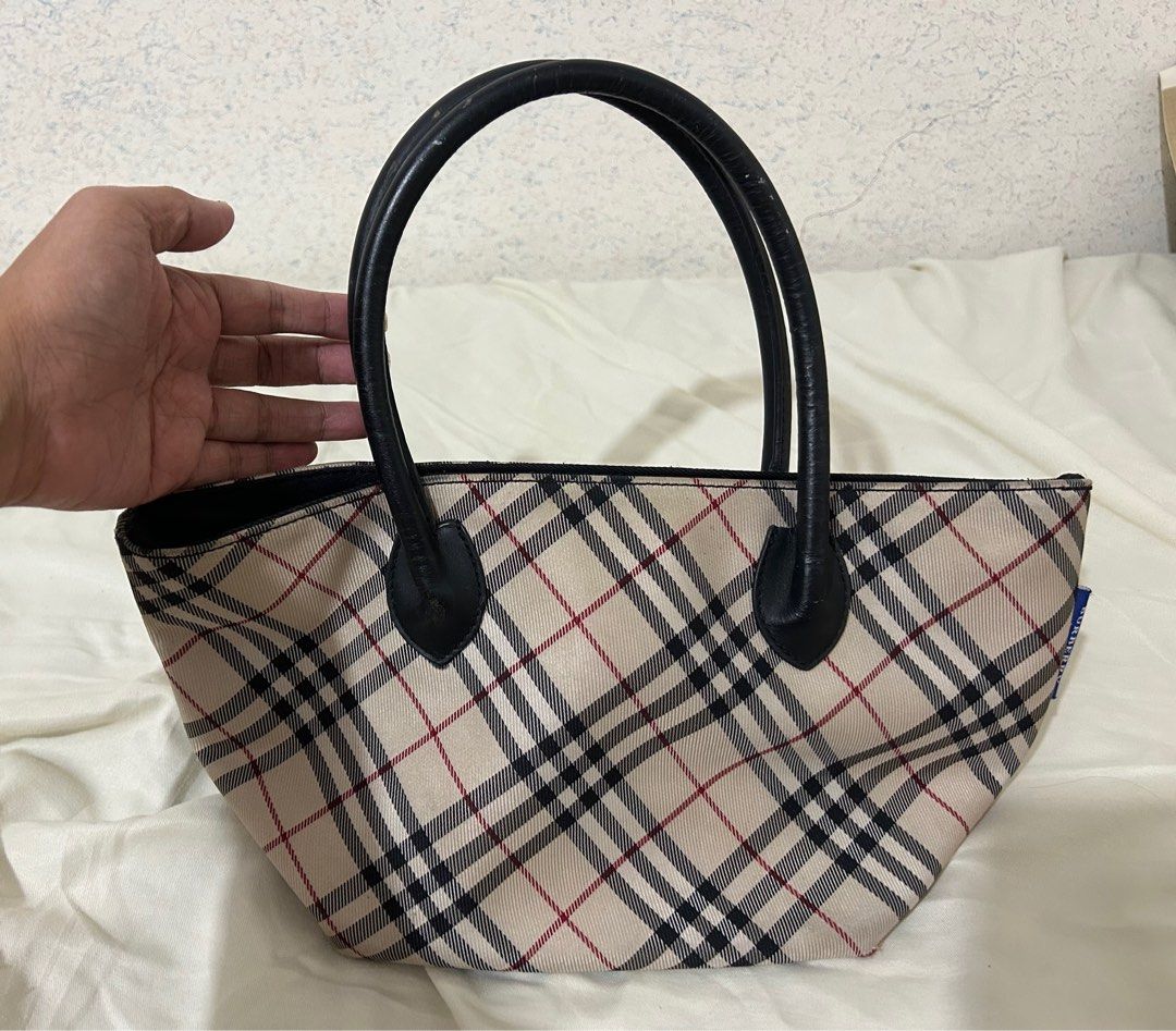 Burberry Blue Label Handbag (Category: Luxury Bags & Wallets) located in Cabanatuan. Submitted by krnlim (Listing ID 1414626565, Image 1). Description: - Authentic Burberry Blue Label handbag - Classic Burberry check pattern - Black leather handles - Secure zipper closure - Features the Burberry of London Blue Label logo on the zipper pull - Includes a visible blue label tag.