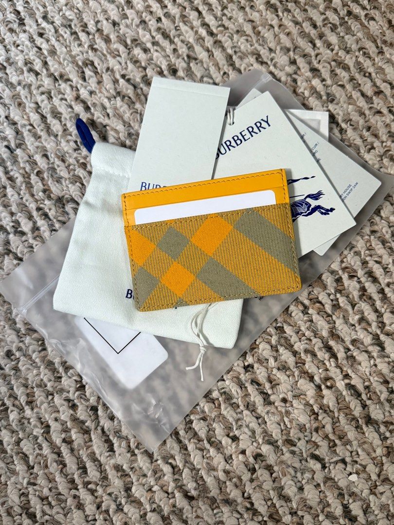 Burberry Card Holder (Category: Luxury Bags & Wallets) located in Manila. Submitted by Authentic_Seller (Listing ID 1414665834, Image 2). Description: Brand new Authentic Burberry card holder Yellow and plaid design Includes original tags and dust bag Multiple card slots Made in Italy with central note slot Warranty card, care card, leaflets.