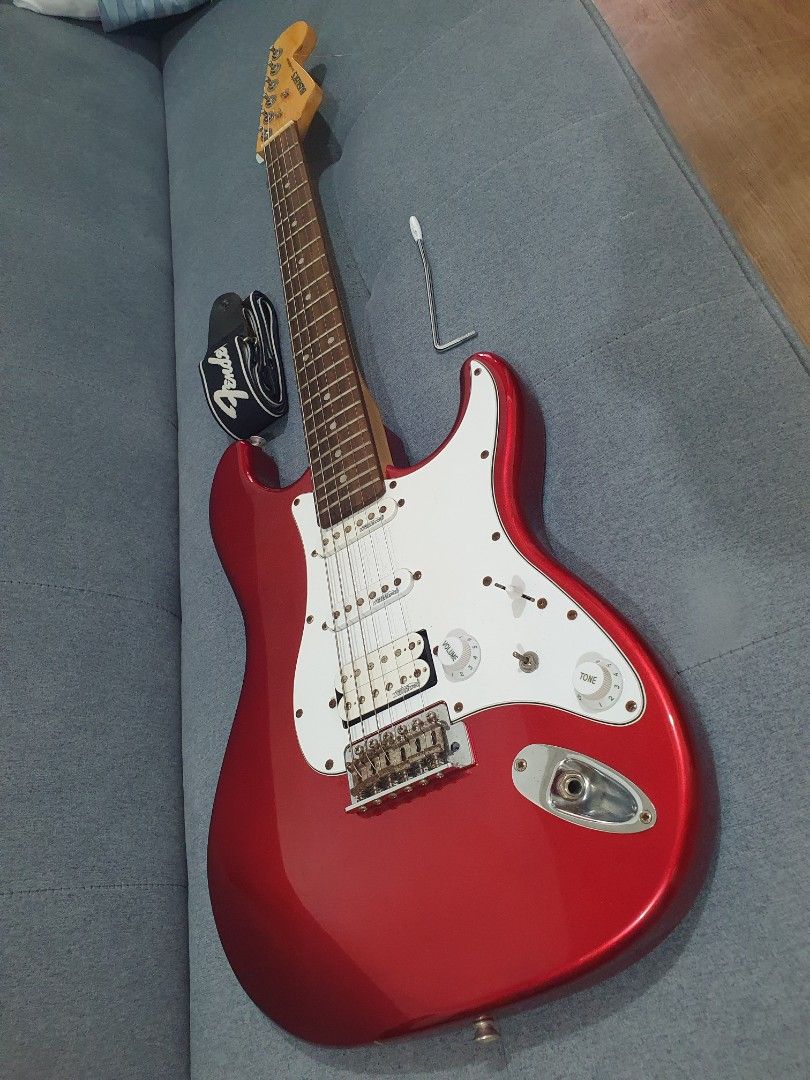 Busker's Red Electric Guitar (Category: Musical Instruments) located in Paranaque City. Submitted by ghanreagan15.1 (Listing ID 1414672371, Image 3). Description: - Red Busker's electric guitar - White pickguard - Three pickups - Glossy red finish - Includes strap and wrench - Busker's logo on headstock - 6 strings note slightly rust hardware but Good condition and action comes with tremolo guitar strap and free guitar stand - Tuning pegs.