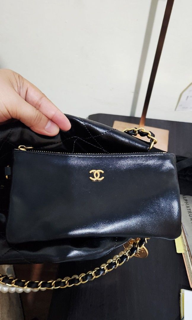 Chanel 22 Mini Handbag (Category: Luxury Bags & Wallets) located in Caloocan City. Submitted by wearandcarry (Listing ID 1403345333, Image 3). Description: - Chanel 22 Mini Handbag in black shiny crumpled calfskin with a pearl strap - Gold chain and pearl chain detail - Gold Chanel logo - Sleek, glossy finish - Perfect for evening events - pre❤️ - dustbag - microchipped.