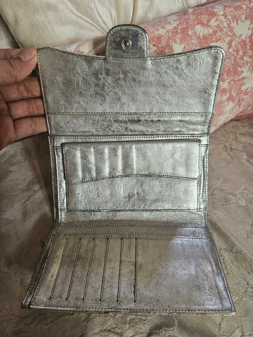 Chanel Silver Quilted Wallet (Category: Luxury Bags & Wallets) located in Santa Rosa. Submitted by pb_reg (Listing ID 1414637541, Image 2). Description: - Chanel silver quilted wallet - Flap closure - Multiple card slots and compartments - Fabric lining - hologram intact - Chanel logo engraved clasp FOR TAKE ALL Please see individual posts for more photos 1. Louis Vuitton keepall 55 bandouliere - great condition - minor wear on vachetta - see pho