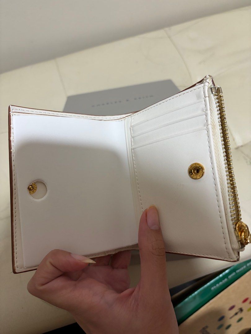 Charles & Keith White Braided Wallet (Category: Wallets & Card holders) located in Taguig. Submitted by ky_declutterss (Listing ID 1414653802, Image 3). Description: - Braided design - Zip-around and snap closures - Multiple interior compartments - Comes with original box - Good as new (only used it for one day lol) - Last price posted - RFS: impulse buy.