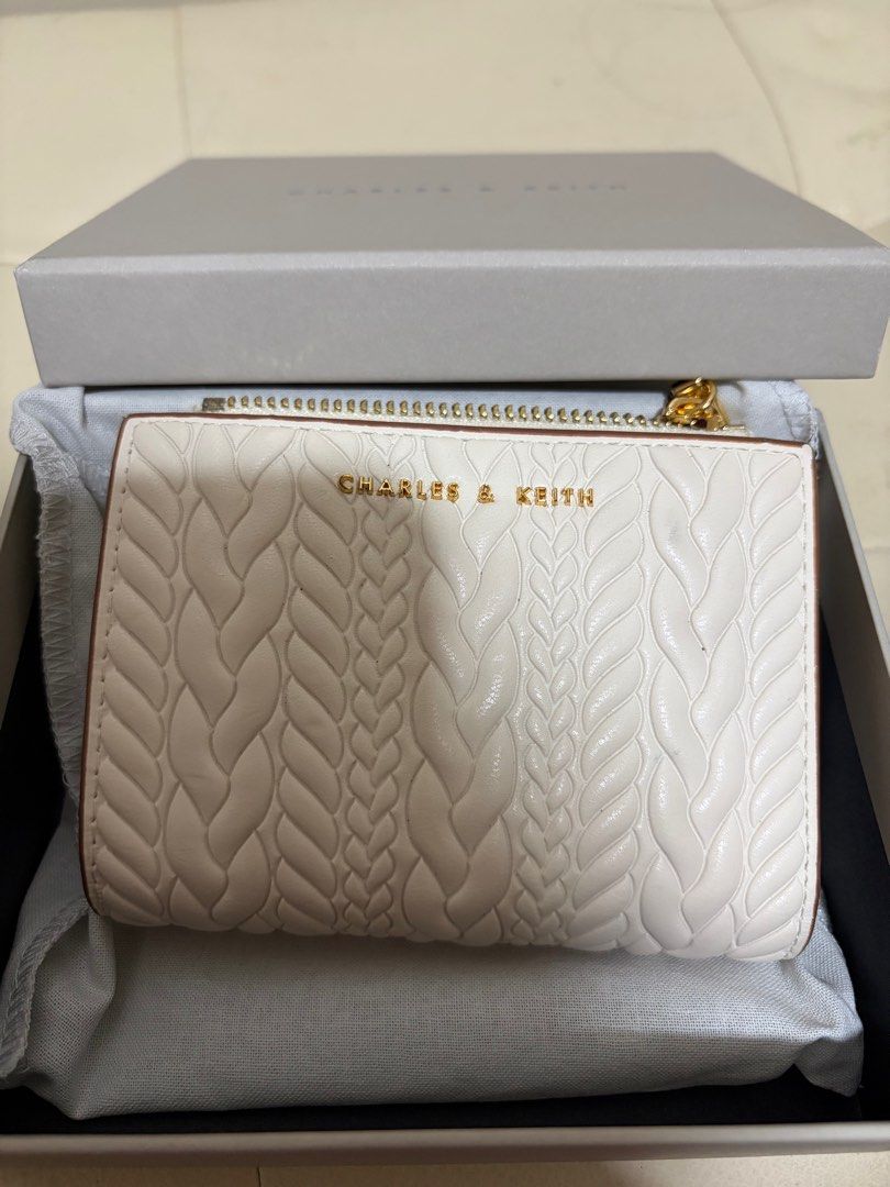 Charles & Keith White Braided Wallet (Category: Wallets & Card holders) located in Taguig. Submitted by ky_declutterss (Listing ID 1414653802, Image 1). Description: - Braided design - Zip-around and snap closures - Multiple interior compartments - Comes with original box - Good as new (only used it for one day lol) - Last price posted - RFS: impulse buy.