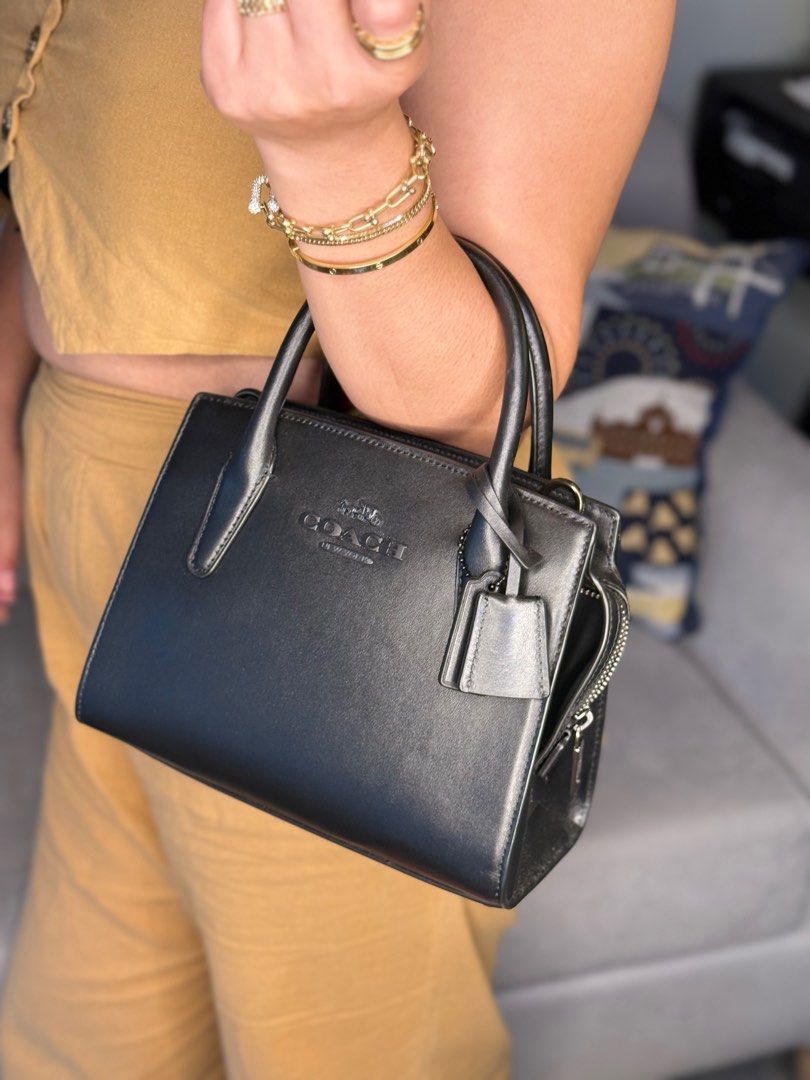 Coach Andrea Carryall (Category: Luxury Bags & Wallets) located in Manila. Submitted by ahmazing (Listing ID 1414711798, Image 2). Description: - Coach Andrea Carryall - Color: Black - Features: - Top handle - Detachable shoulder strap - Zip closure - Coach hang tag - Embossed Coach logo - Material: Leather - Complete Inclusion - Country of origin: 🇯🇵.
