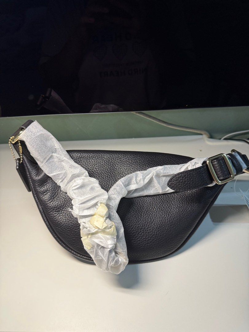 Coach Black Leather Waist Bag (Category: Luxury Bags & Wallets) located in Cavite. Submitted by nicainics (Listing ID 1414737183, Image 3). Description: - Brand new Coach waist bag - Crafted from black leather - Elegant gold-tone zipper and hardware - Features a main compartment for essentials - Includes an interior pocket for organization - Comes with a detachable strap for versatile wear - Includes a signature Coach hangtag.