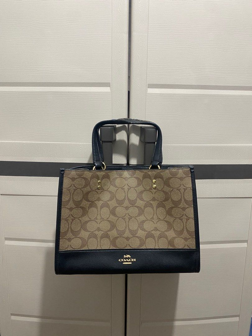 Coach Signature Tote Bag (Category: Luxury Bags & Wallets) located in Tacloban City. Submitted by luxefind12345 (Listing ID 1414668976, Image 1). Description: - Authentic Coach tote bag - Classic Coach monogram pattern - IDEAL zipper - Black leather base and handles - Top handle - Magnetic snap closure - Interior zip pocket - Gold-tone hardware - Includes Coach hangtag - Made in Indonesia.