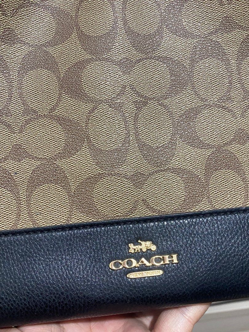 Coach Signature Tote Bag (Category: Luxury Bags & Wallets) located in Tacloban City. Submitted by luxefind12345 (Listing ID 1414668976, Image 3). Description: - Authentic Coach tote bag - Classic Coach monogram pattern - IDEAL zipper - Black leather base and handles - Top handle - Magnetic snap closure - Interior zip pocket - Gold-tone hardware - Includes Coach hangtag - Made in Indonesia.