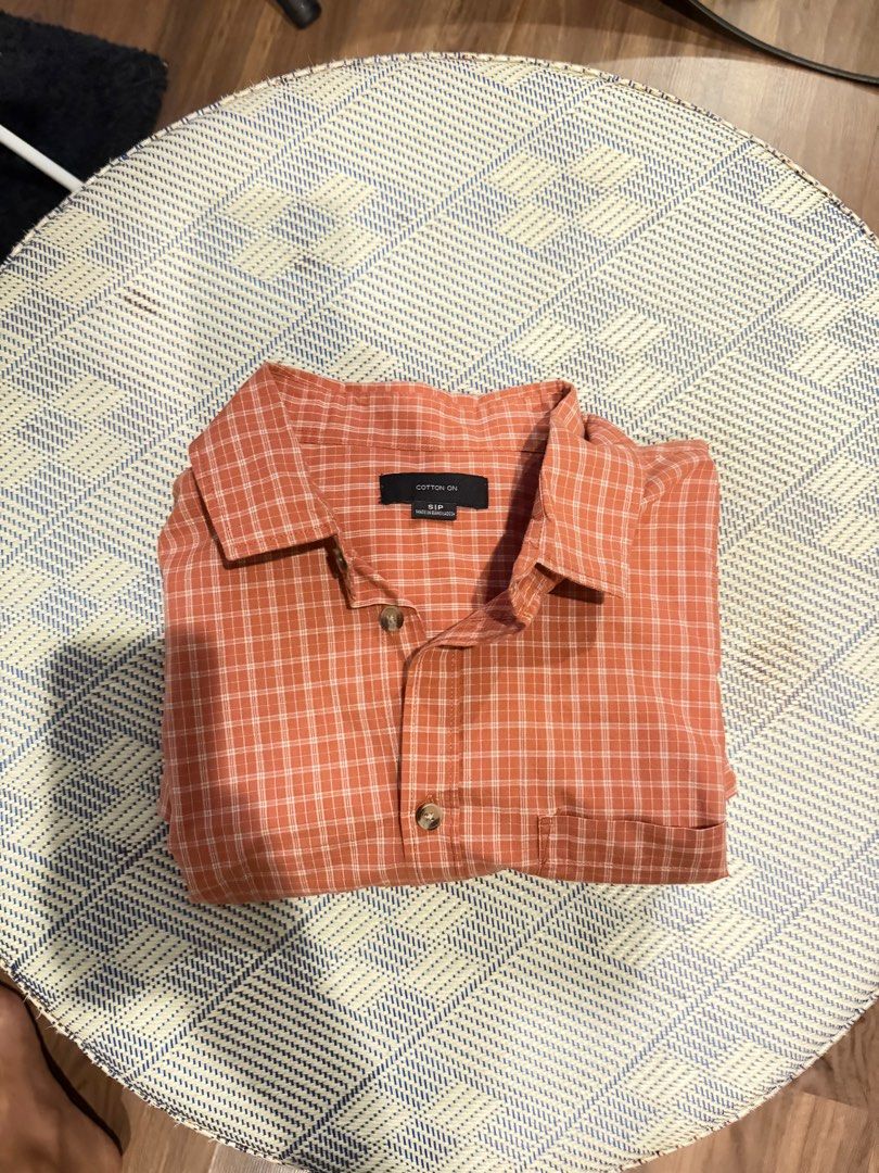 Cotton On Checkered Polo (Category: Tshirts & Polo Shirts ) located in Taguig. Submitted by e_prc (Listing ID 1414744255, Image 3). Description: - Cotton On short-sleeved shirt - Checkered pattern - Button-down front - Chest pocket - Relaxed fit - Color: Reddish-orange - Size: S/P - Ideal for casual wear.