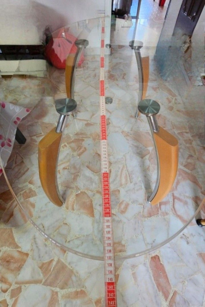 Dining Table (Category: Tables & Sets) located in Singapore. Submitted by ed_de_rick (Listing ID 1414653583, Image 3). Description: - Oval dining table - Clear glass top - Wooden legs - Dimensions: 137cm (L) x 81cm (W).