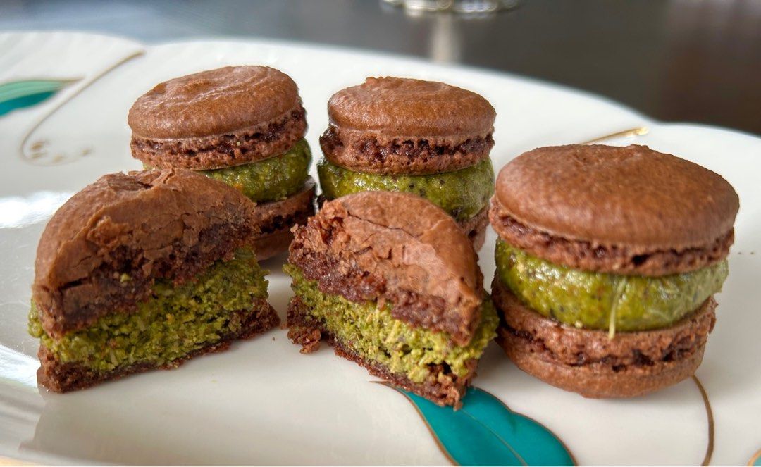 Dubai Chocolate Pistachio Macarons (Category: Homemade Bakes) located in Paranaque City. Submitted by runnerako (Listing ID 1414638565, Image 1). Description: My version of the famous Dubai chocolate pistachio confection in macaron form. Chocolate macaron shells filled generously with homemade pistachio cream with crunchy kataifi. Baked as ordered to maintain freshness. Lead time is about 2-3 days depending on schedule. 8 pcs per order Location: 