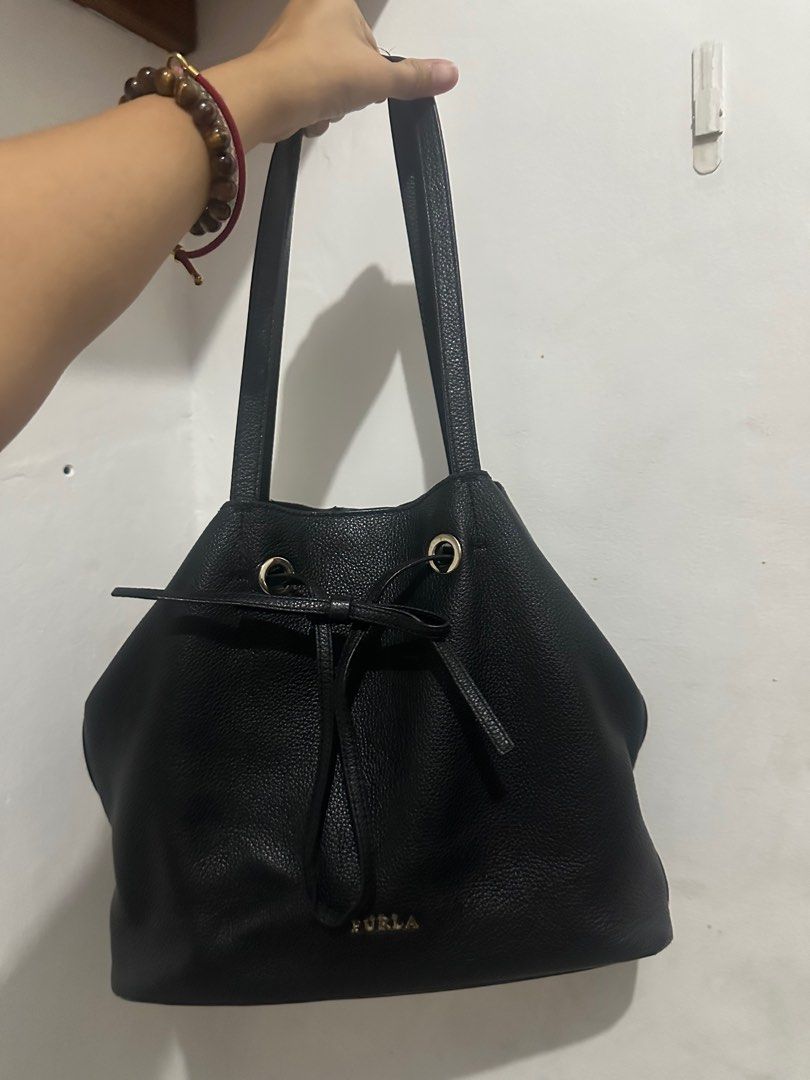 Furla Genuine Leather Drawstring /Bucket Bag (Category: Luxury Bags & Wallets) located in San Juan City. Submitted by maeootd (Listing ID 1414808248, Image 2). Description: - Authentic Furla handbag - Minor wear on handles ( see photos) - Genuine leather - Spacious din, kasya Ipad - Super nice, one of my personal favorites.