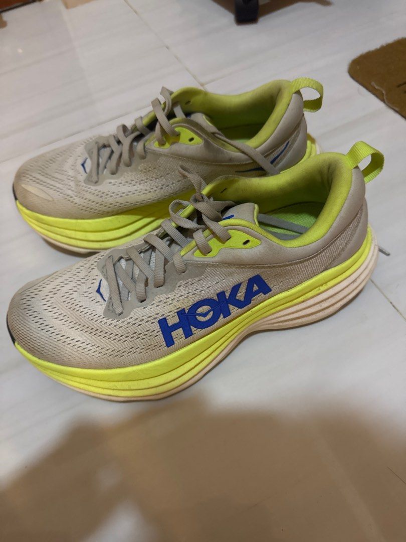 Hoka Bondi 8 Running Shoes (Category: Sneakers) located in Cabanatuan. Submitted by amirdecluttersph (Listing ID 1414726287, Image 1). Description: - Hoka Bondi 6 running shoes - Color: Grey and Neon Yellow - Size: US 7, UK 6.5, EU 40, JPN 25 - Visible wear on soles and uppers - Features the Hoka logo.