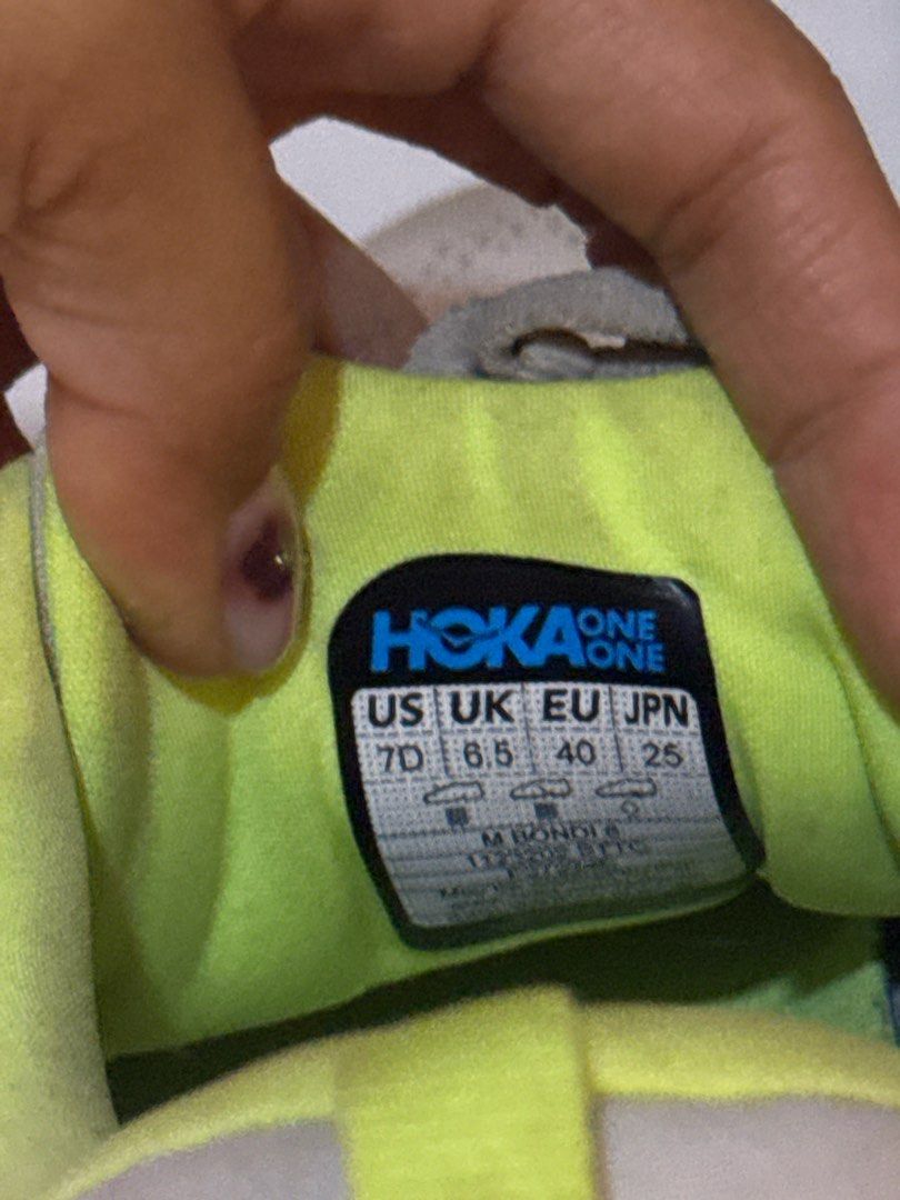 Hoka Bondi 8 Running Shoes (Category: Sneakers) located in Cabanatuan. Submitted by amirdecluttersph (Listing ID 1414726287, Image 3). Description: - Hoka Bondi 6 running shoes - Color: Grey and Neon Yellow - Size: US 7, UK 6.5, EU 40, JPN 25 - Visible wear on soles and uppers - Features the Hoka logo.
